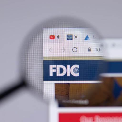An image of a computer screen with a magnifying glass enlarging the acronym FDIC, which is the ultimate protection for business cash.