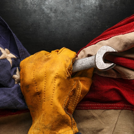 Labor unions represented by a worker’s glove grasping a wrench and an American Flag.